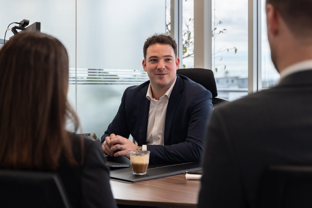 Business advisor having coffee with clients